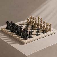Coral and black marble chess set on display — Stone & Game