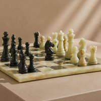 Close-up of green onyx and black marble chess pieces in play — Stone & Game