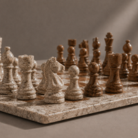 Close-up of cream marble chess pieces on brown board — Stone & Game