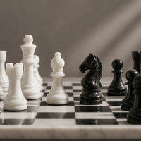 Black marble knight facing white marble bishop — Stone & Game