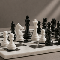 Black and white marble chess kings and queens mid-game — Stone & Game