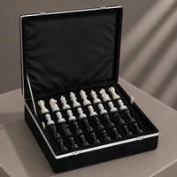 Black and white marble chess pieces in velvet storage case — Stone & Game