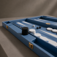 Blue leather backgammon set detail with black and white pieces — Stone & Game