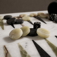 Green onyx and black marble backgammon pieces close-up — Stone & Game