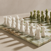 White marble chess pieces on green onyx board — Stone & Game