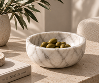 Carrara marble bowl styled as fruit bowl on dining table
