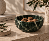 Green marble bowl styled as fruit bowl on dining table