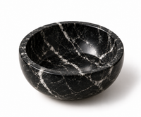 Black marble bowl close-up showing white and grey veining