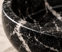 Black marble decorative bowl in modern interior