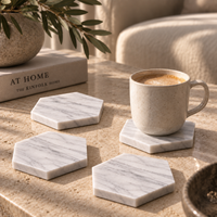 Stack of Carrara marble hexagon coasters showing protective underside pads