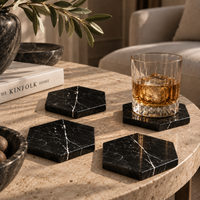 Black marble coasters styled on table with wine glasses