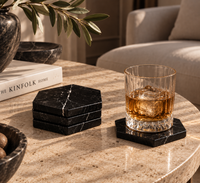Black marble coaster set in modern living room interior
