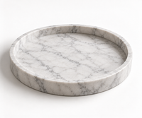 Round Carrara marble tray styled with candles and perfume