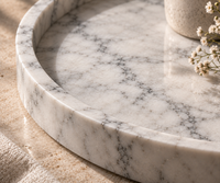 Round Carrara marble tray in minimalist home interior