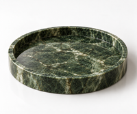 Round green marble tray close-up showing golden veining