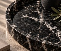 Round black marble tray in modern interior