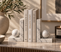 Carrara marble bookends holding books on shelf