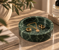 Green marble catchall tray holding rings and jewelry