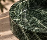 Green marble catchall tray in bathroom interior