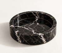 Black marble catchall tray close-up showing white veining