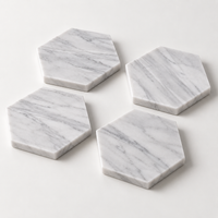 Carrara marble coasters styled on coffee table with drinks