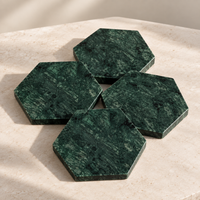 Stack of green marble hexagon coasters showing protective underside pads