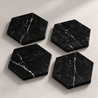 Black marble hexagon coaster close-up showing white veining detail