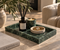 Green marble tray styled with candles and perfume bottles