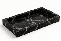 Black marble tray close-up showing white veining detail