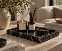 Black marble tray styled with candles and jewelry