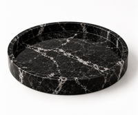 Round black marble tray styled with candles and decor